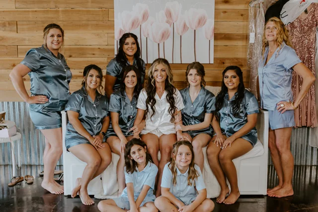 Friends pose together against the warm wood walls