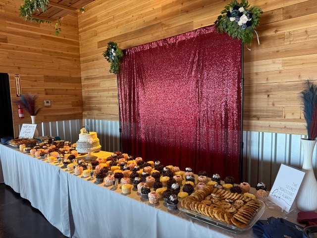Dessert table with autumn flowers and burgundy draping