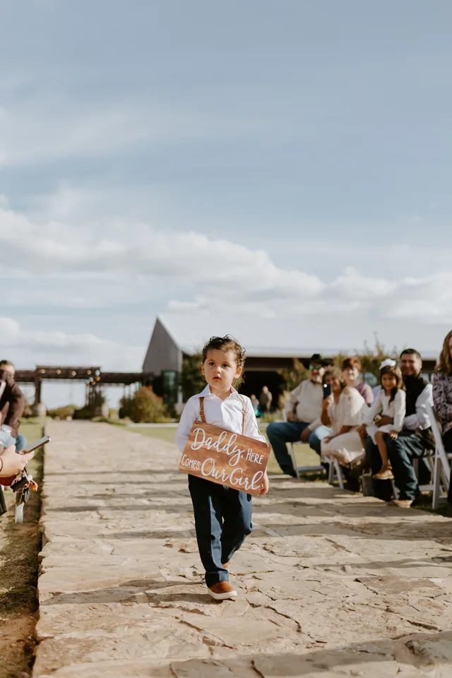 A young guest walks across the courtyard during a wedding
