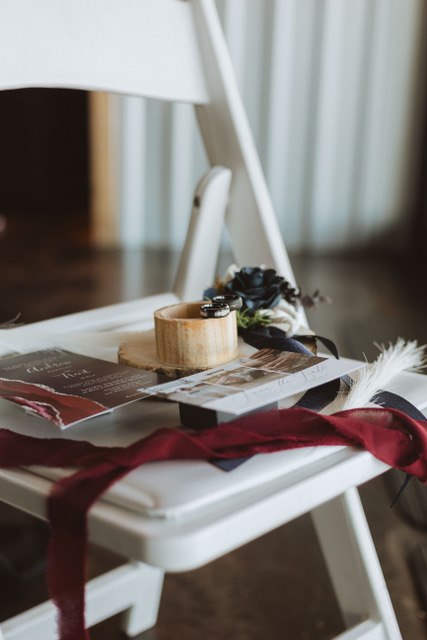 Red runner and feather accents at a reception place setting