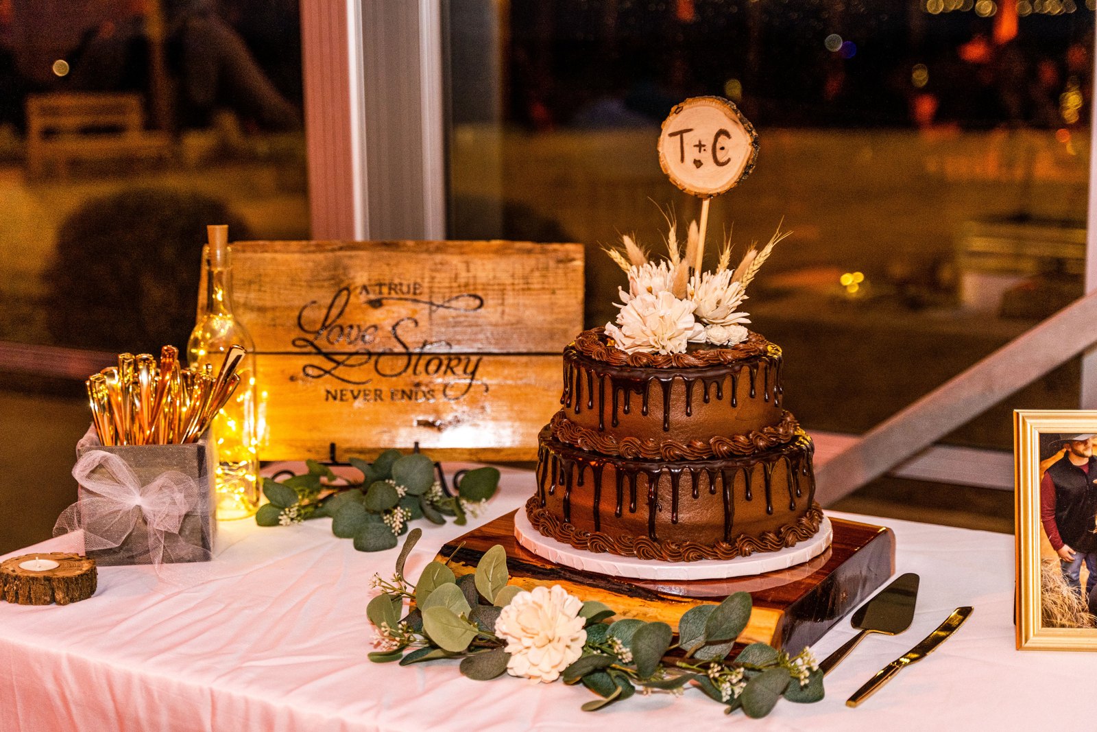Wedding cake with gold accents and a decorated dessert table