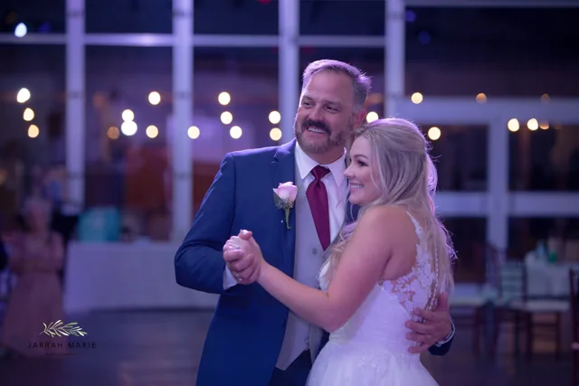 A bride and a loved one share a dance at the reception