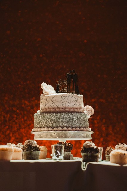 Tiered wedding cake on a decorated display table
