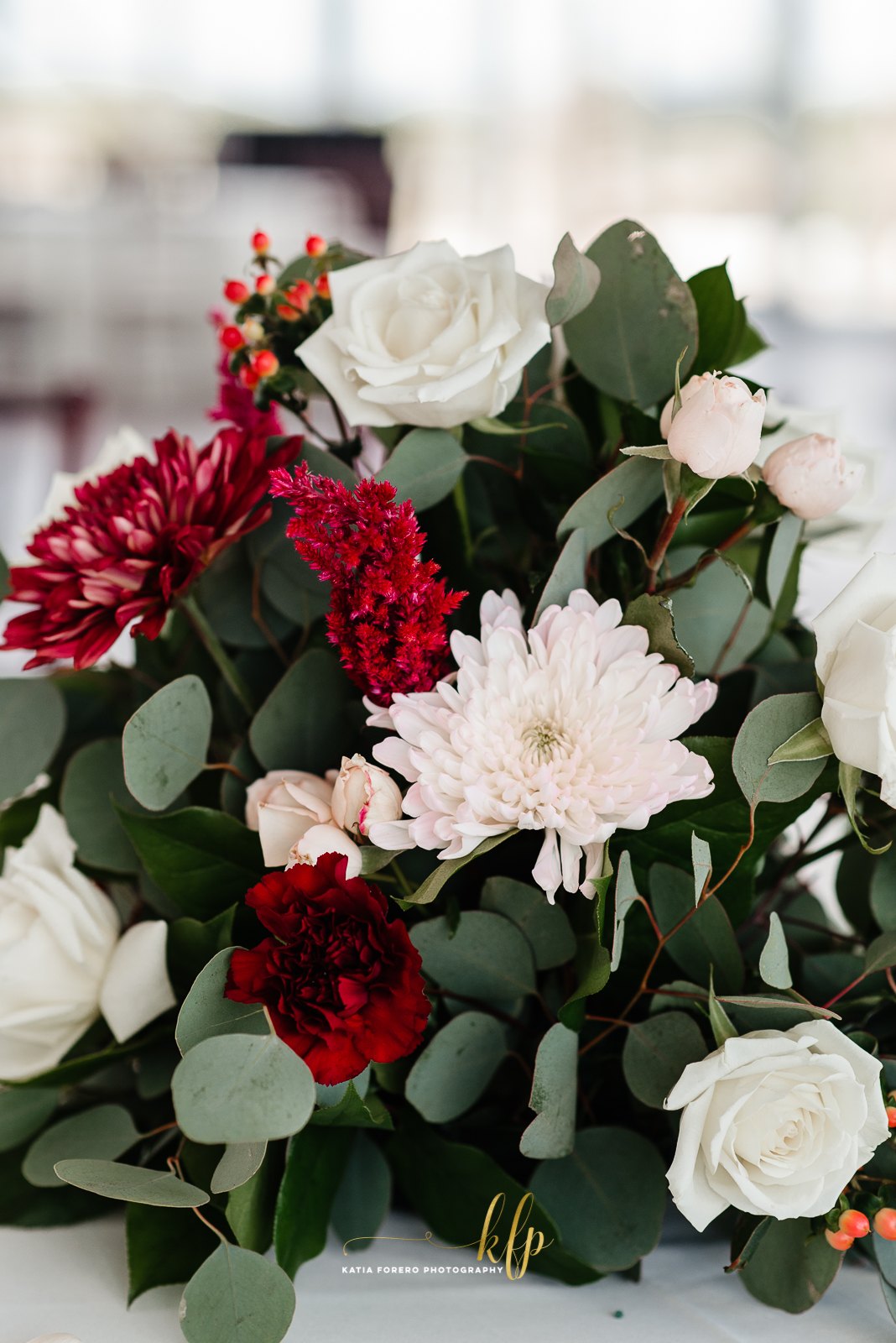 Red and white roses arranged with greenery