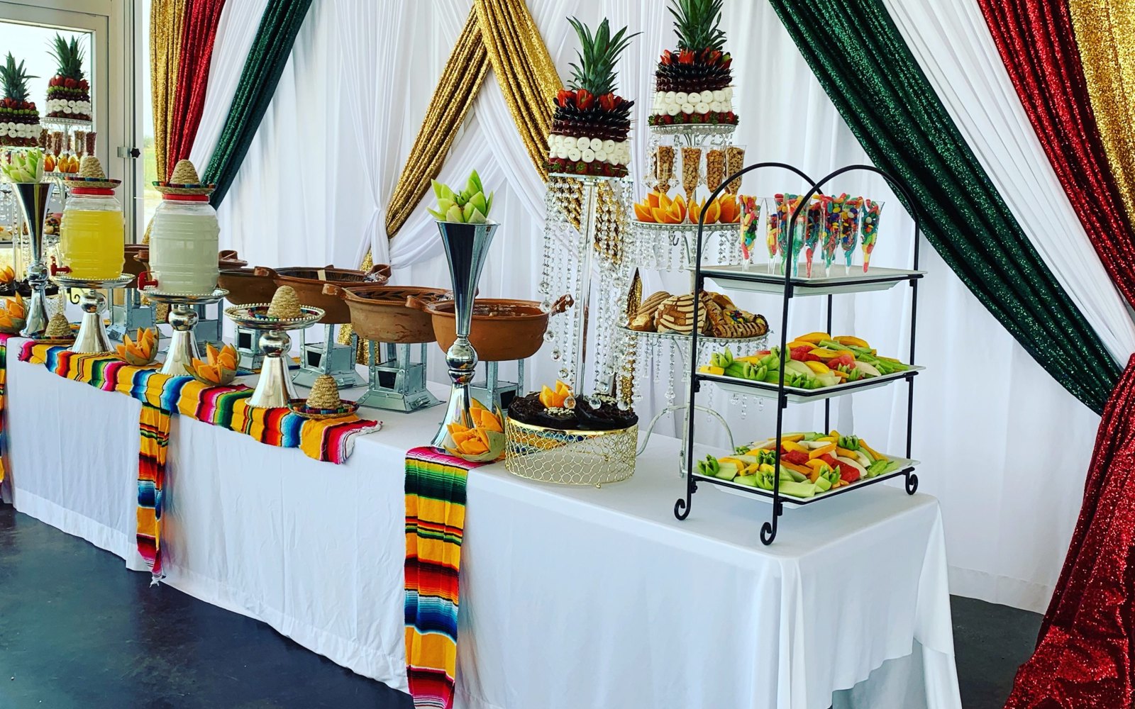 Colorful dessert display framed by fabric drapes