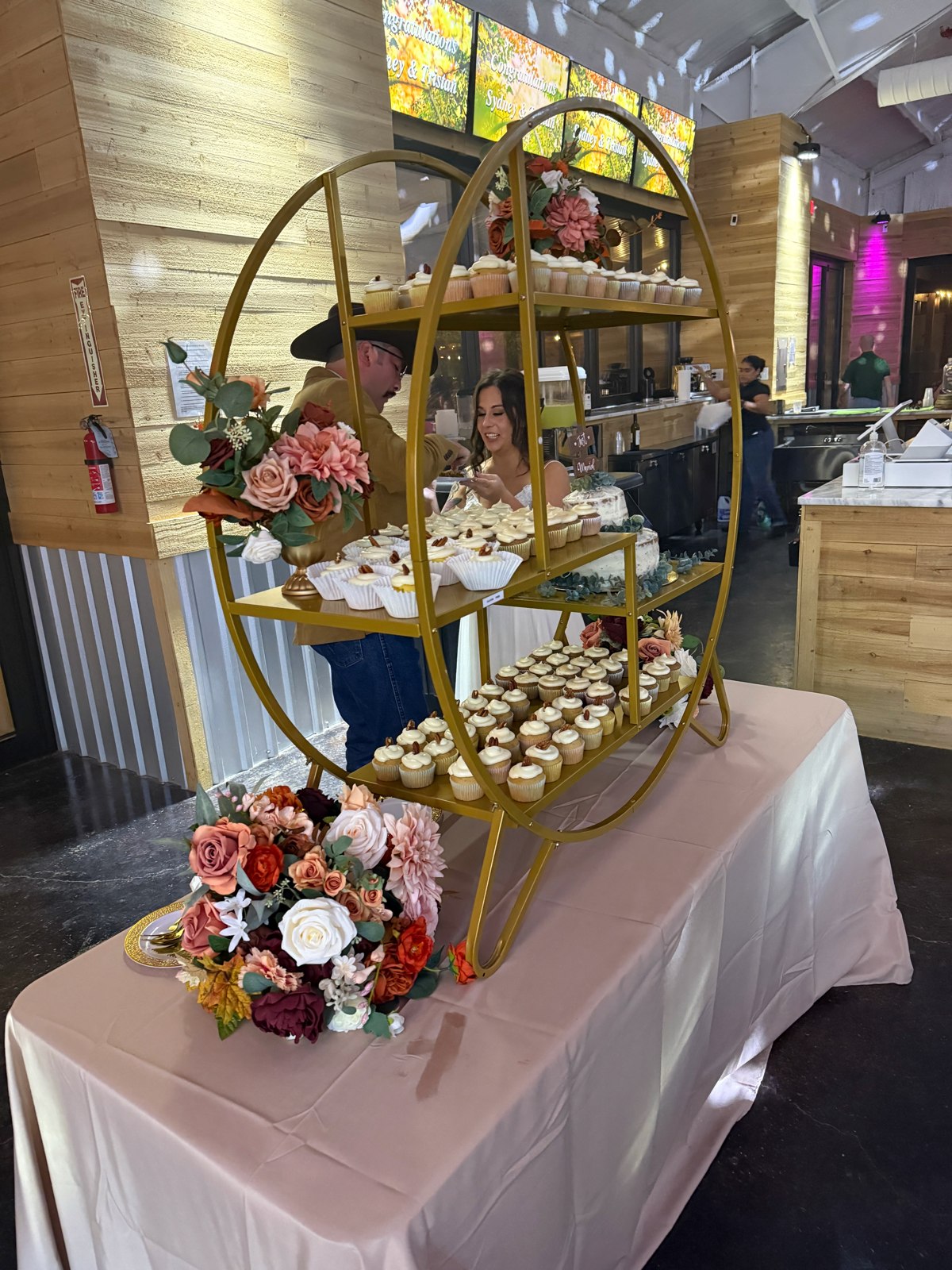 A dessert display with greenery and floral accents