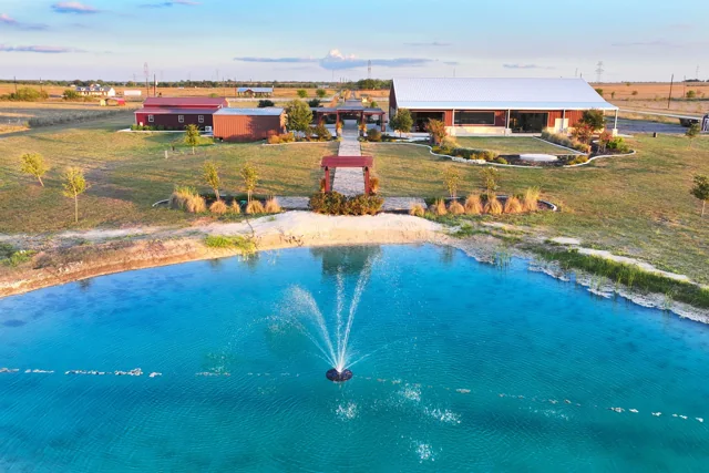An aerial view of the pond and ranch grounds