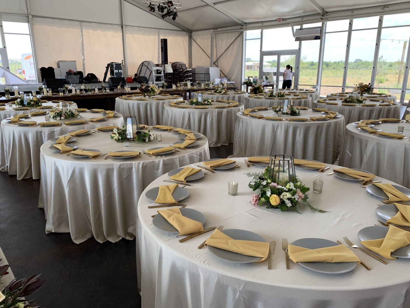 Cream table linens with greenery and gold place settings