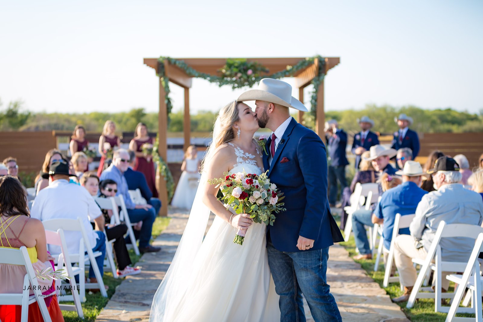 Newlyweds celebrate in the outdoor ceremony aisle at Enchanted Ranch