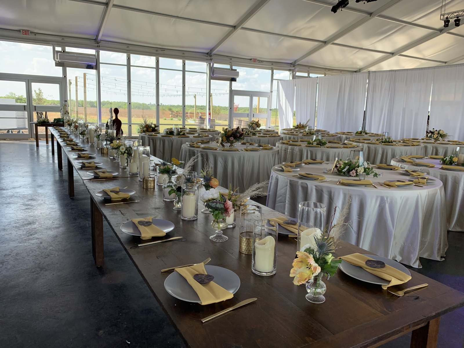 Coordinated white and gold reception tables with floral centerpieces