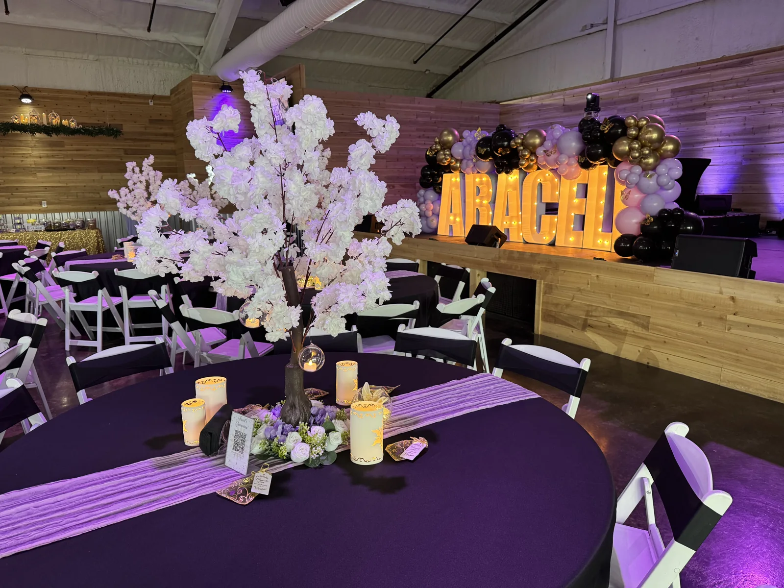 Illuminated marquee letters with balloons and purple reception décor