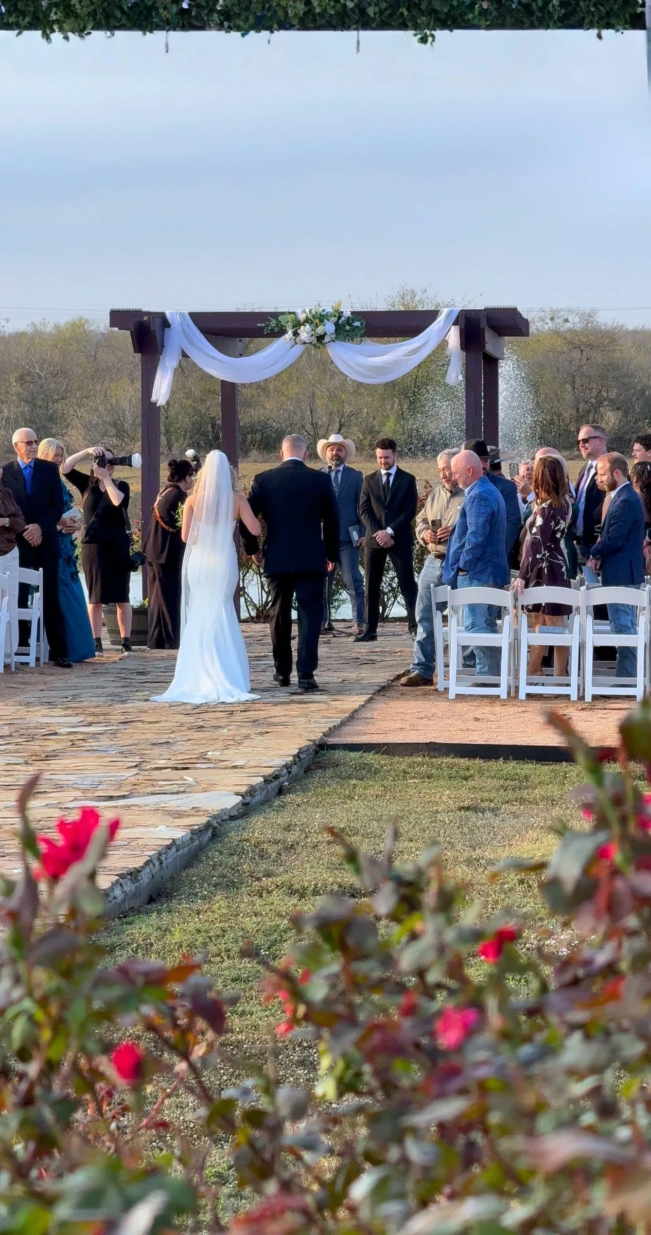 A wedding ceremony beneath the outdoor arbor