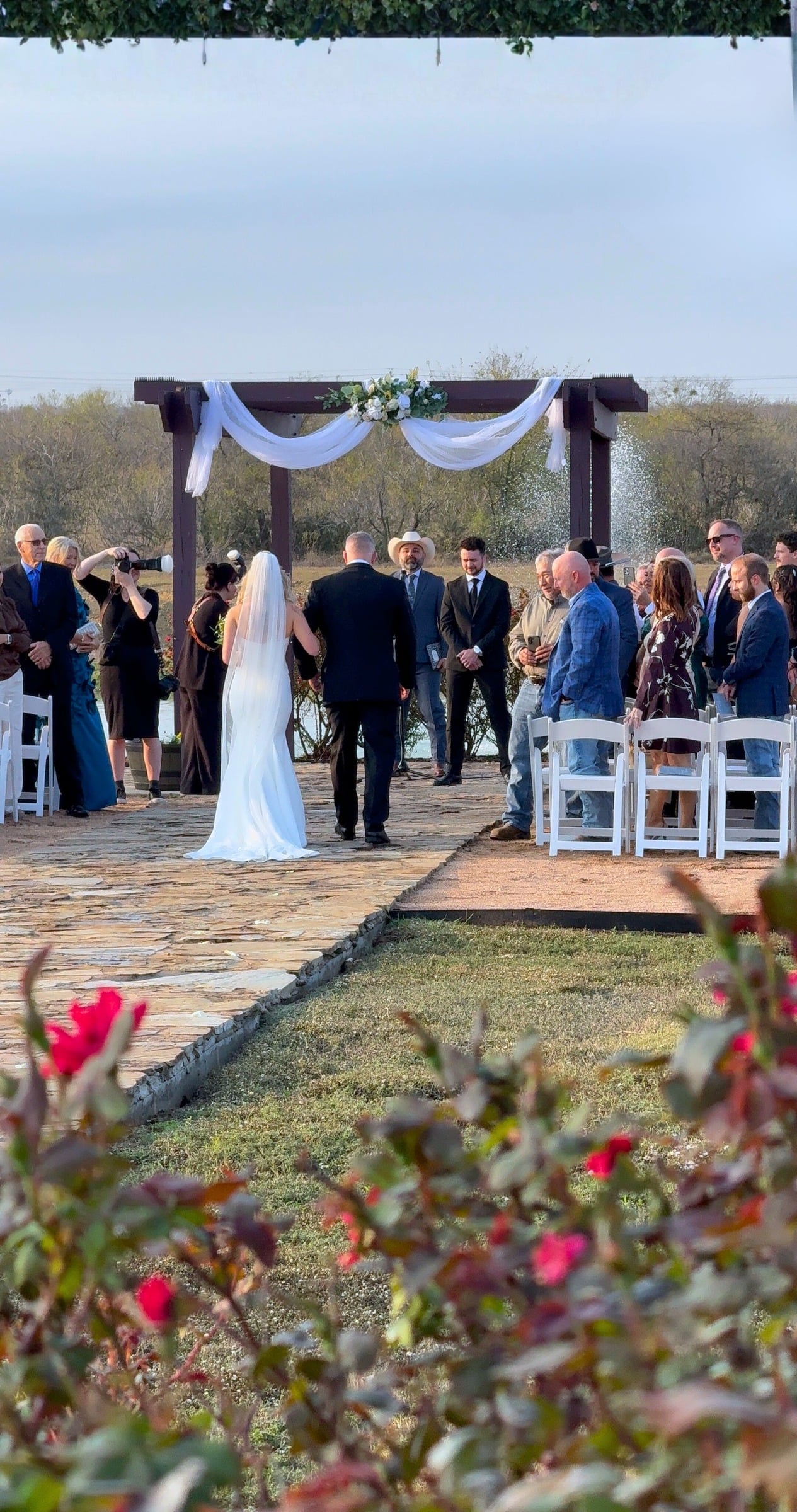 A wedding ceremony beneath the outdoor arbor