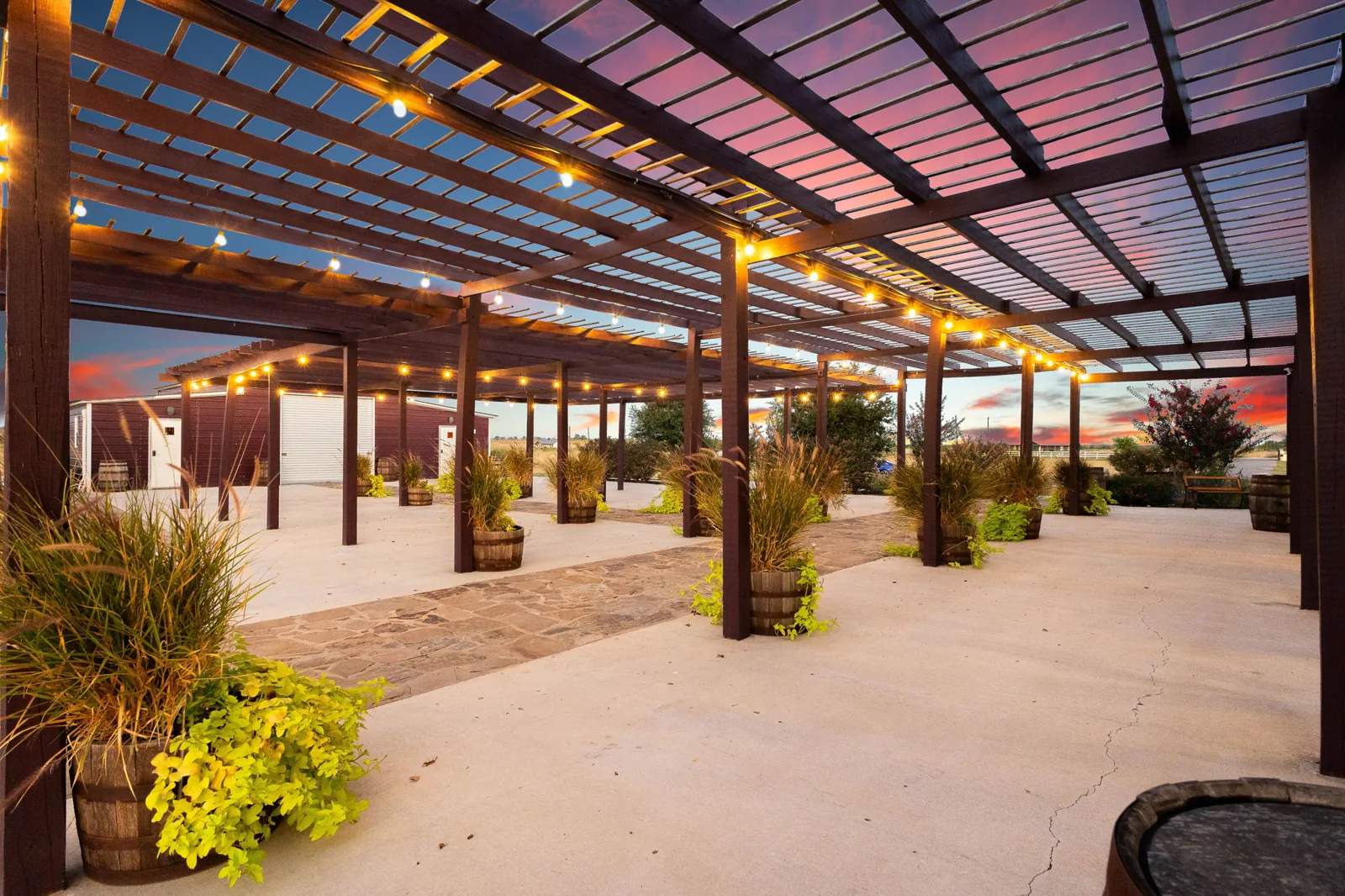 The covered pergola and courtyard at Enchanted Ranch in warm evening light