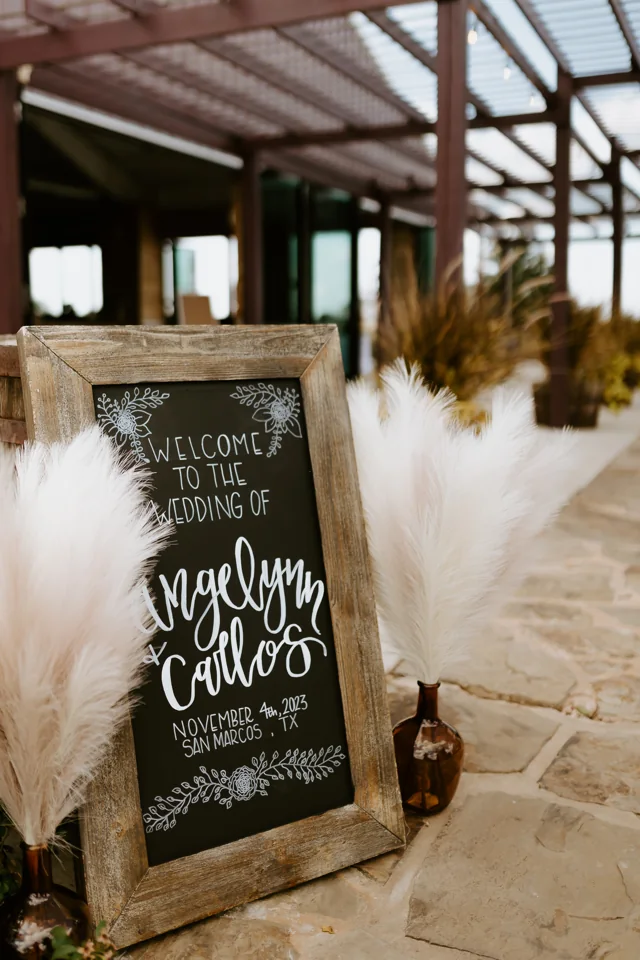 A welcome sign and white flowers beside the courtyard