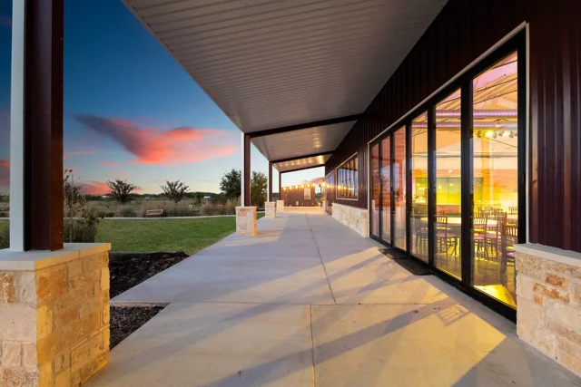 Warm sunset light along the glass-fronted reception hall
