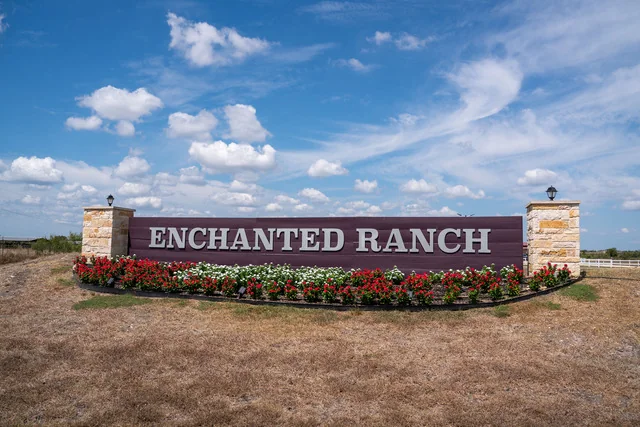 The Enchanted Ranch entrance sign beneath a bright blue sky