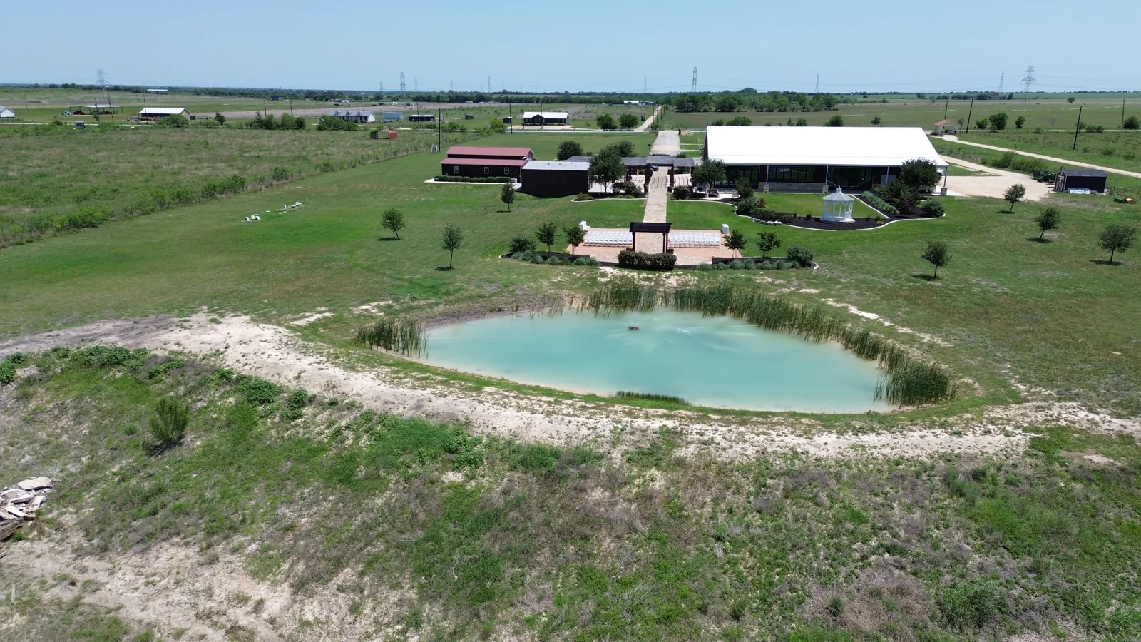 The Enchanted Ranch venue and pond seen from above in daylight