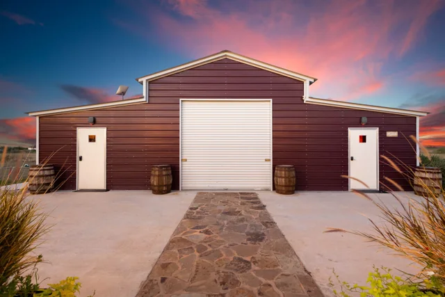 The barn-style ranch exterior at sunset