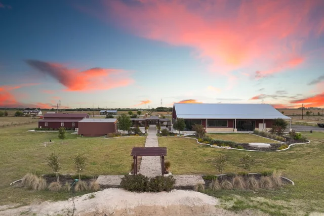 An aerial view of the ceremony area and reception building at dusk