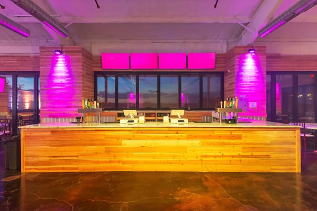 The indoor stage lit in purple and pink
