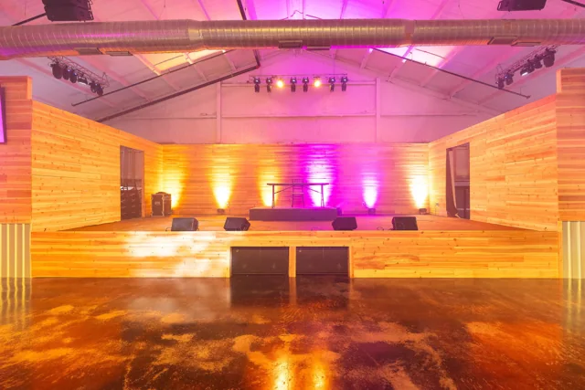 Warm uplighting along the indoor reception walls
