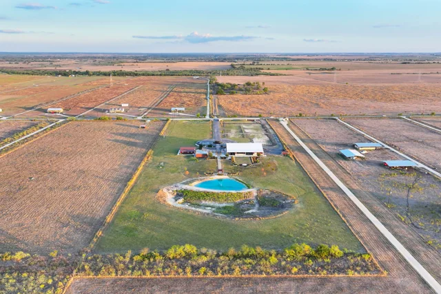 A wide aerial view of the ranch and surrounding Texas countryside