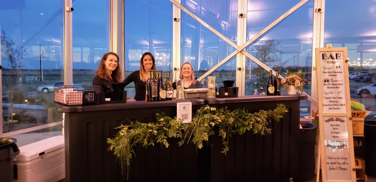 Smiling bar staff welcome guests at the ranch reception bar