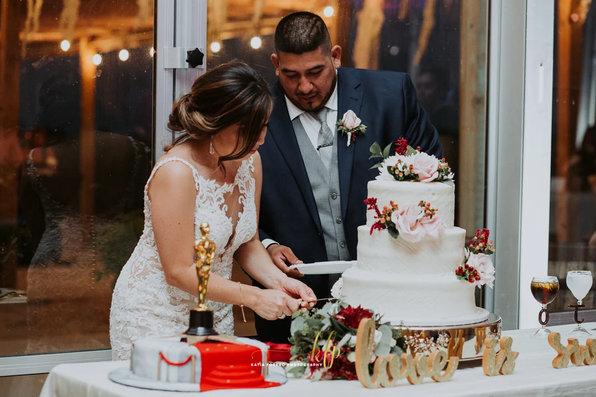 A bride and groom cut their wedding cake together at Enchanted Ranch