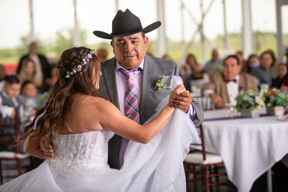 The ranch event hall opens toward its outdoor pergola at sunset